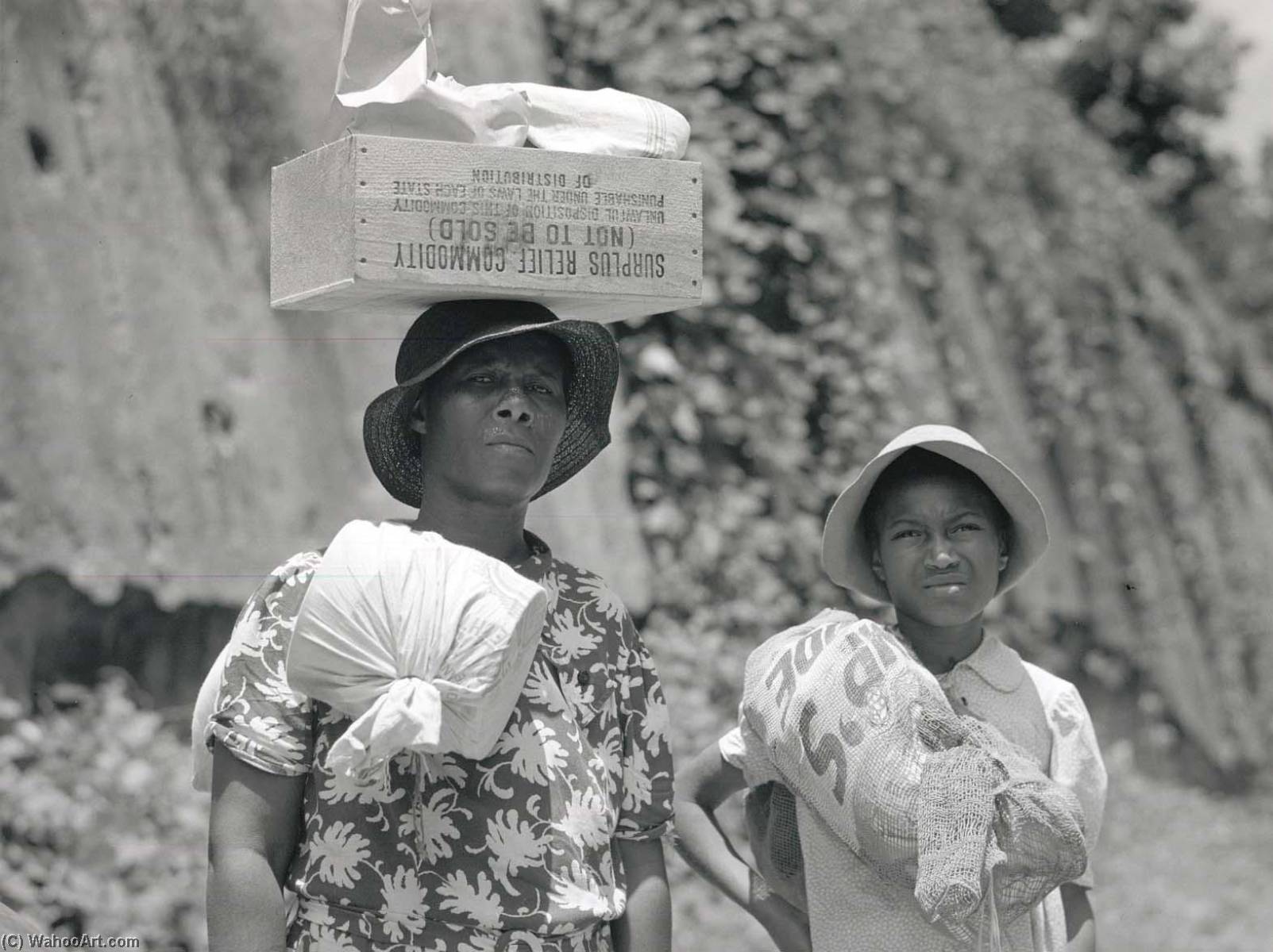 Two Negro Women Carrying Packages, One Has A Box Of Surplus Relief Commodities On Her Head. Natchez, Mississippi — Marion Post Wolcott