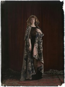 Model wearing a printed silk velvet\ndress and cape