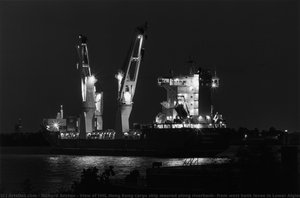View of HHL Hong Kong cargo ship moored along riverbank; from west bank levee in Lower Algiers