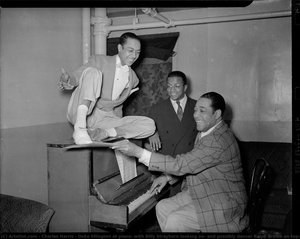 Duke Ellington At Piano, With Billy Strayhorn Looking On, And Possibly Dancer Ralph Brown On Top, Backstage In Stanley Theatre — Charles Harris