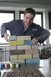 Dr Sam Chpaman with sustainably engineered bricks