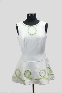 Tinling tennis dress with looping design in green and yellow ribbon and white lace detail worn by Judy Dalton