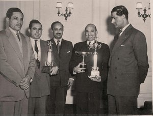 Hashim Khan with trophies (centre) with Azam Khan with trophy (second from left) and Roshan Khan (extreme left). Circa 1950s