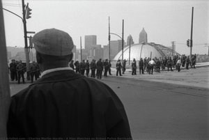 A Man Watches as Armed Police Barricade the Street Before Pittsburgh Peace March