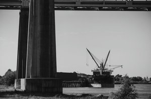 View of cargo ship docked at Perry Street Wharf; from west bank levee in Algiers Point, New Orleans