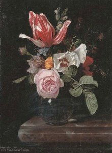 Roses, peonies, a tulip and other flowers in a glass vase on a stone ledge