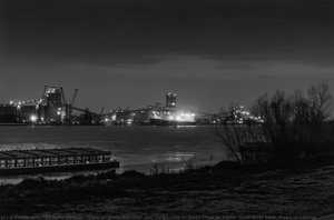 View of grain elevator and cargo ship in Destrehan at night; from west bank levee in Luling