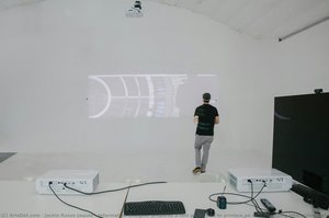 Information designer prepares a test projection to preview an accompanying interactive installation inside the Ira Gershwin Gallery, inside Walt Disney Concert Hall.