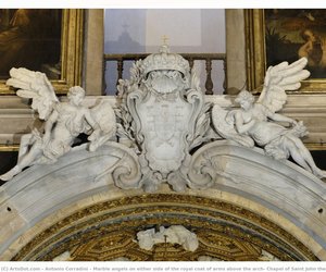 Marble angels on either side of the royal coat of arms above the arch, Chapel of Saint John the Baptist