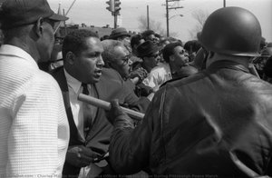 A Police Officer Raises His Baton During Pittsburgh Peace March