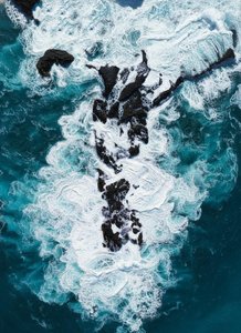 Fractured Resilience: An Aerial Study in Obsidian and Foam