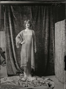 Model wearing a Delphos dress and printed silk tunic