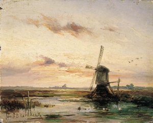 A windmill in a polder landscape at sunset