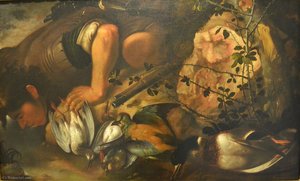Hunter drinking from a stream with game birds