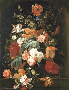 Flowers in a glass vase on a stone