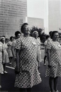 Untitled (women In Patterned Dresses Marching) — Burk Uzzle