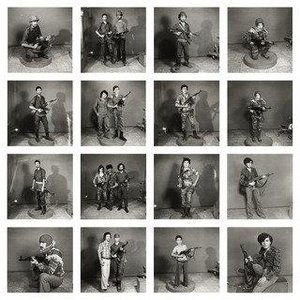 After They Got The Right To Arms. Fourteen Young Men Posing With Guns — Akram Zaatari