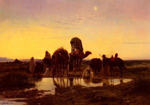 Camel train by an oasis at dawn