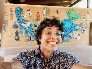 Suzy González self portrait with mural